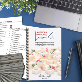 A book sitting on top of a table next to a laptop.