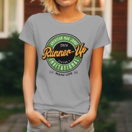 Woman wearing a gray T-shirt with a colorful runner-up championship design.